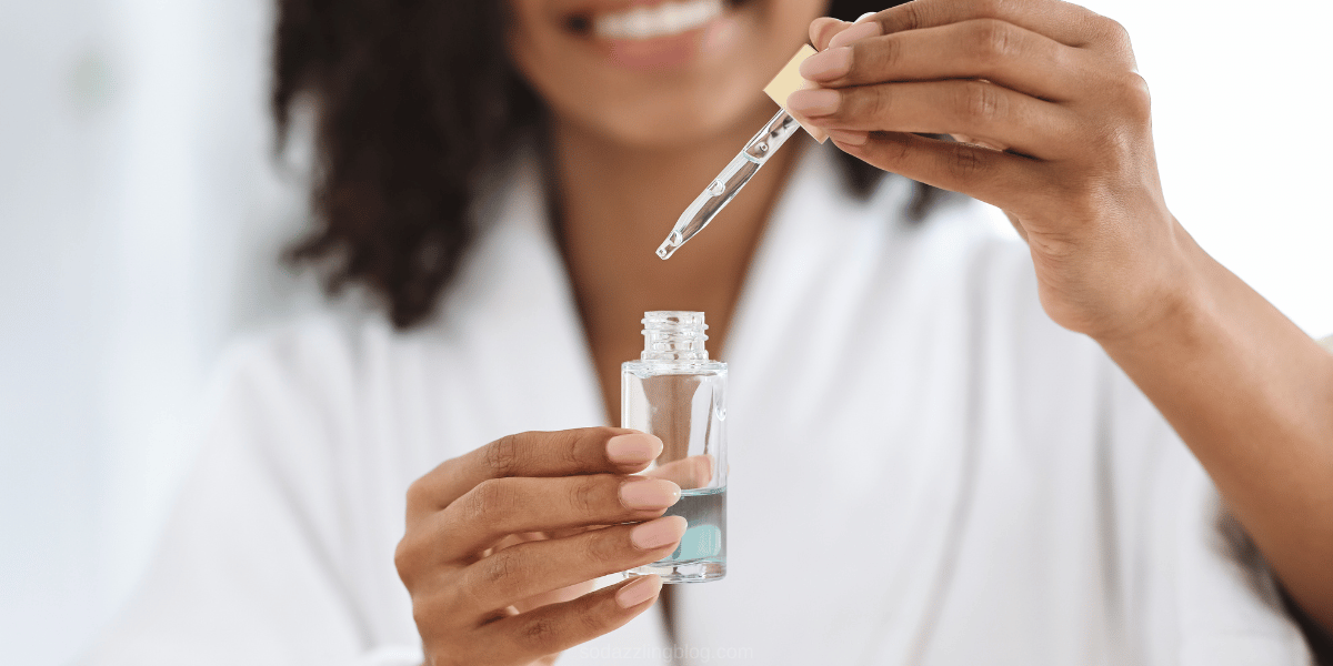 Image of woman holding a vial with a blue serum. This is the banner image for a blog post that talks about PHAS in Skincare and breastfeeding safe skincare