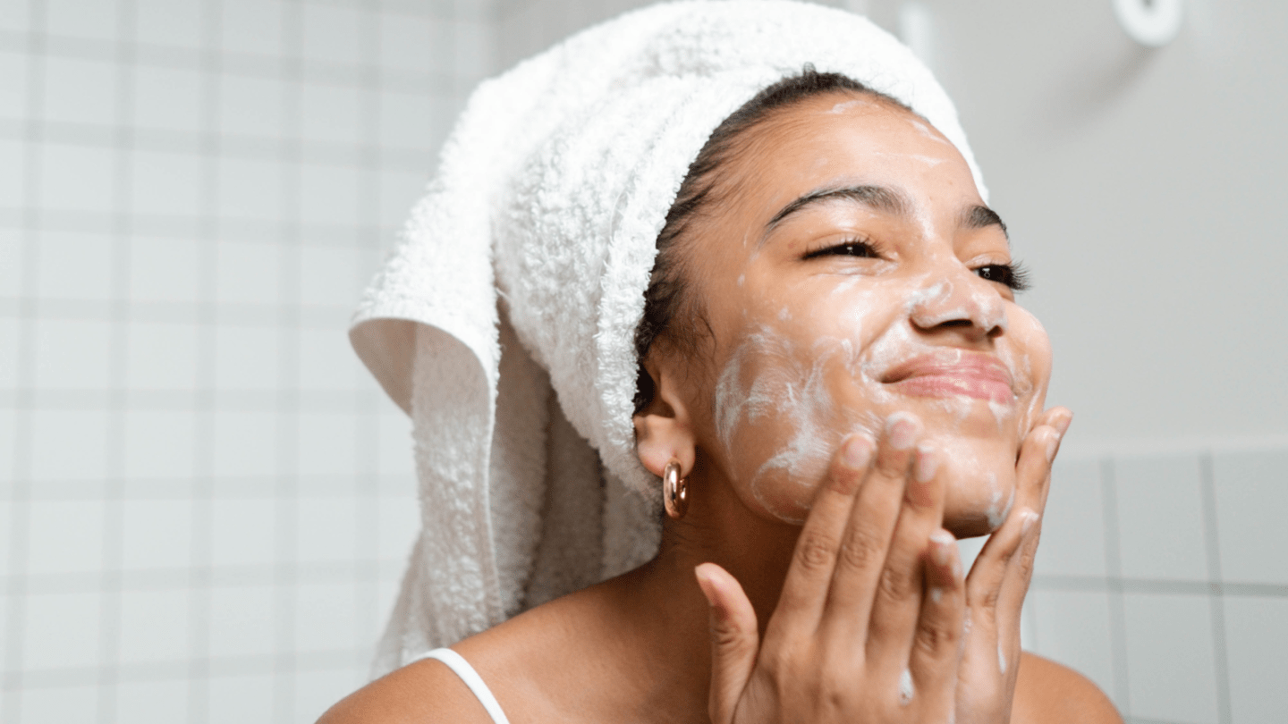 Affordable skin care brands 2023 blog post banner image - woman with white bowl on head washing her face