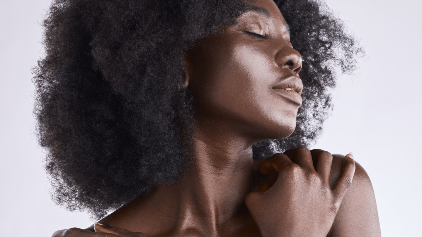 Self-love blog post banner image of dark skinned woman hugging herself