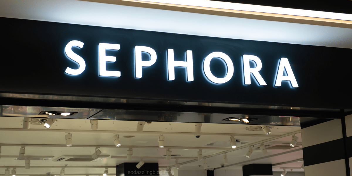 Blog post banner for the Sephora Holiday Savings Event that shows the sign of a Sephora store inside of a mall.